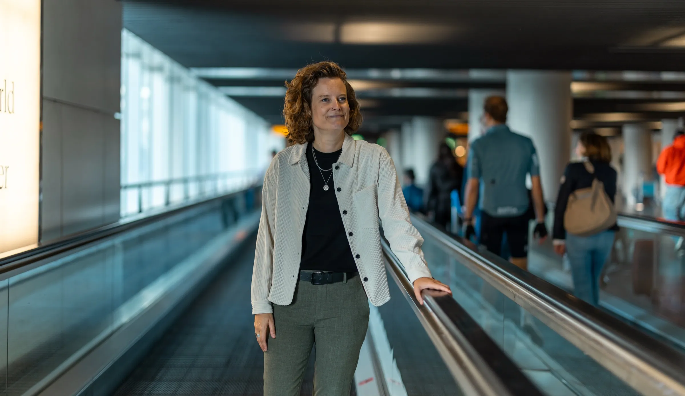Roxanne Allard on a moving walkway at Schiphol Airport
